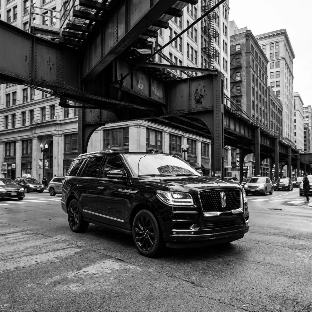 Black Lincoln Navigator under the L tracks in downtown Chicago